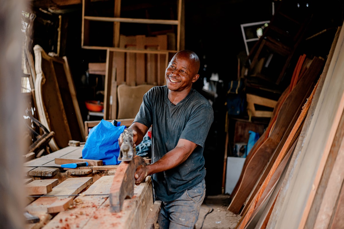 Woodworking & Furniture — craftsman planing wood in a furniture workshop
